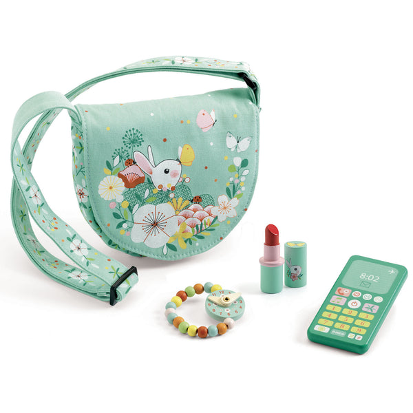 A cotton handbag, beautifully illustrated with rabbits and butterflies, which contains wooden accessories to make like the big ones: a watch, a phone and a lipstick.  A role-play game so little ones can have as much fun as the grown-ups!