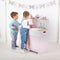 Help your inspiring young chefs cook up a storm with the delightful Pink wooden Country Play Kitchen from Tidlo. This lifelike playset features an oven and hob with clicking dials, a storage cupboard, a Belfast sink, utensil shelves and a clock with moveable hands, to ensure dinner is served on time! 