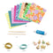 The Djeco set contains everything you need to make beautiful and unique jewelry bracelets. Cut strips of the patterned paper and roll them on the stick for fine beads that you can use for the bracelets.