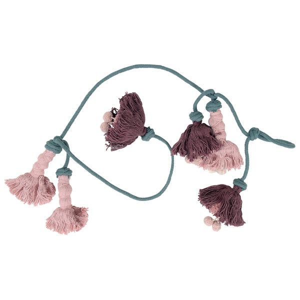 This stunning flower garland is perfect for any part of the home. Every flower is handmade individually by Lorena Canals' expert artisans. The flowers are rose pink and dark aubergine strung on a soft grey garland.