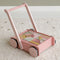 The little dutch block pink trolley is equipped with wooden wheels and filled with coloured wooden blocks featuring beautiful drawings of flowers and insects from the Wild Flowers collection. The different sizes of the blocks promotes children's recognition of colours and shapes. The handle is at the right height for toddlers to walk around the room. This trolley filled with blocks guarantees hours of building fun.