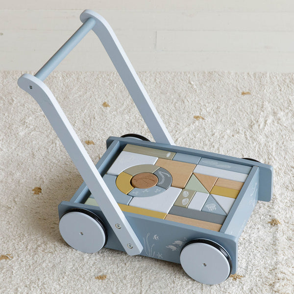 The little dutch blue block trolley is equipped with wooden wheels and filled with coloured wooden blocks featuring beautiful drawings from the Ocean collection such as a whale, shells and water plants. The different sizes of the blocks promotes children's recognition of colours and shapes. 