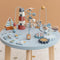 Stand up to play! Discover all the many activities this table has to offer. Help the seagulls bring the beads along the spiral. Or build a lighthouse. Complete the puzzle, turn the wheels and cross the ocean with the little boats. This wooden multi-activity table challenges your little one in many ways. There are 5 activities to explore that each support the development of fine motor skills. 