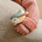This soft rattle bracelet will get your baby excited. Just strap it around your little one’s wrist and let the rattling fun begin. The cuddly bird on top of the bracelet is ready to move! But there is more to explore. Crinkly parts, labels and a little knot encourage grasping and touching. 