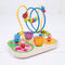 This beautiful, wooden, garden-themed bead frame has a wooden base decorated with illustrations of cute bugs, leaves and flowers. It has a yellow and a blue wire built into it, which loop and intertwine so your rascals can make the beads go up, down over and around in every direction. Some beads include small illustrations matching the theme of the frame while others are solid colours. There are also two small wooden flowers attached to the base coloured pink and orange.